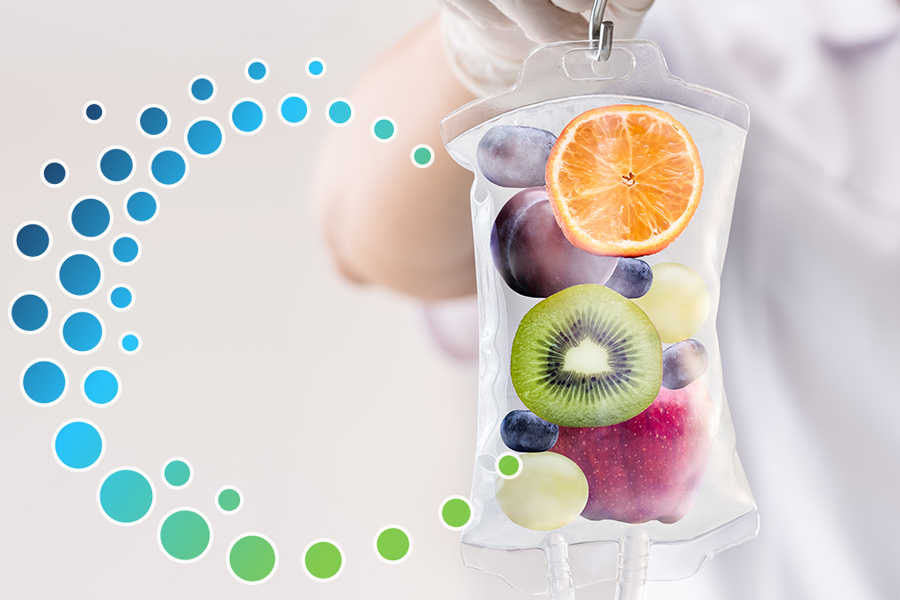 IV Bag filled with water and fruits (orange, grapes, plum, kiwi, apple) depicting the health benefits of IV Therapy.